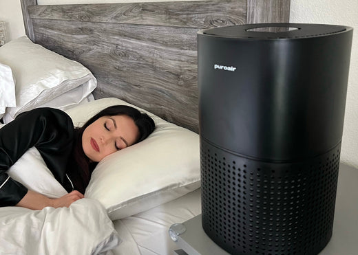 woman sleeping next to an air purifier