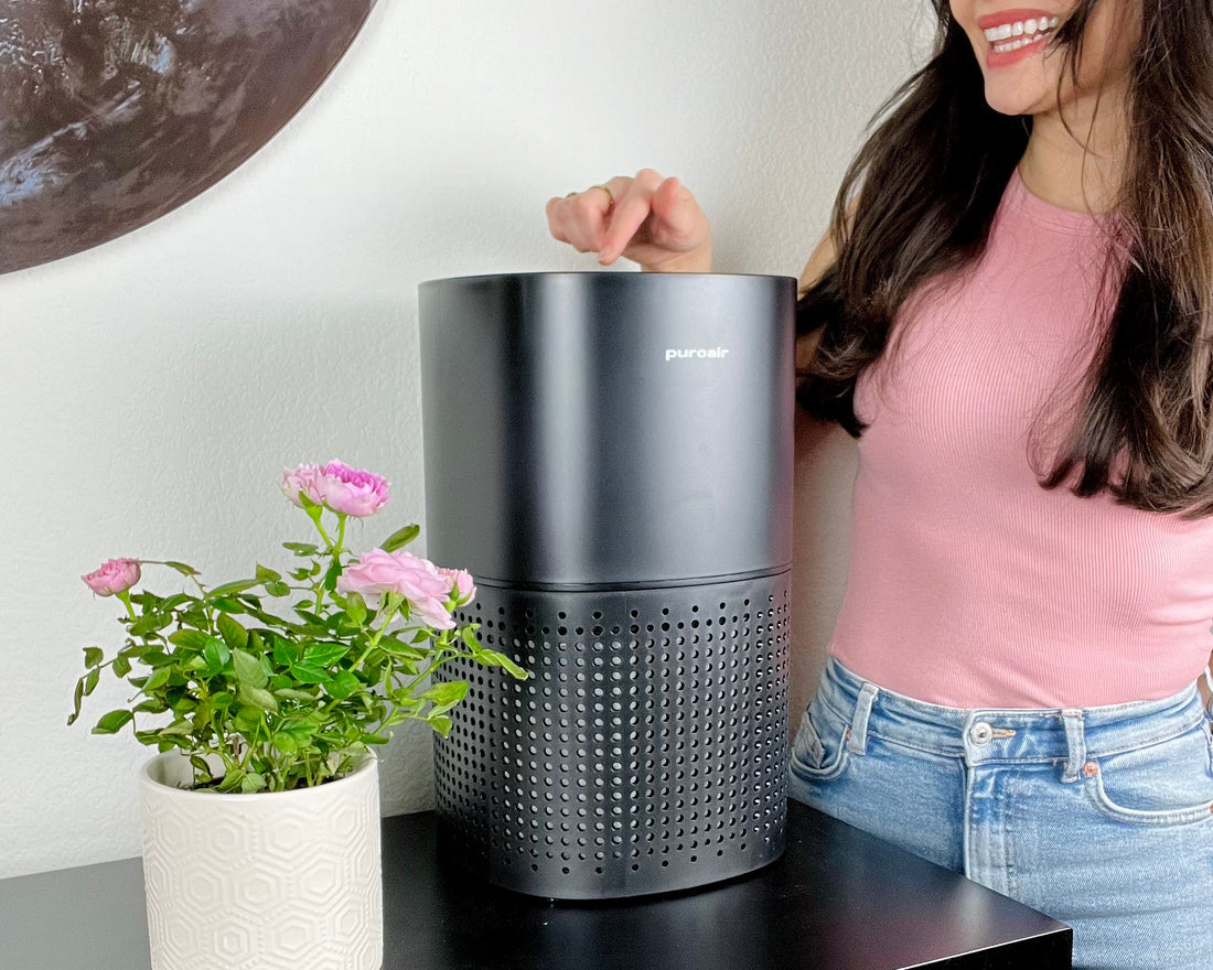 woman turning on an air purifier