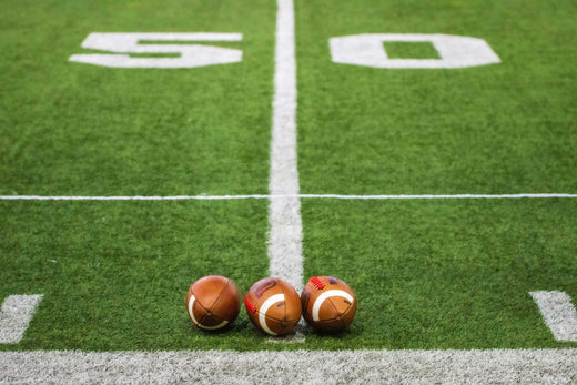 three footballs on the 50 yard line
