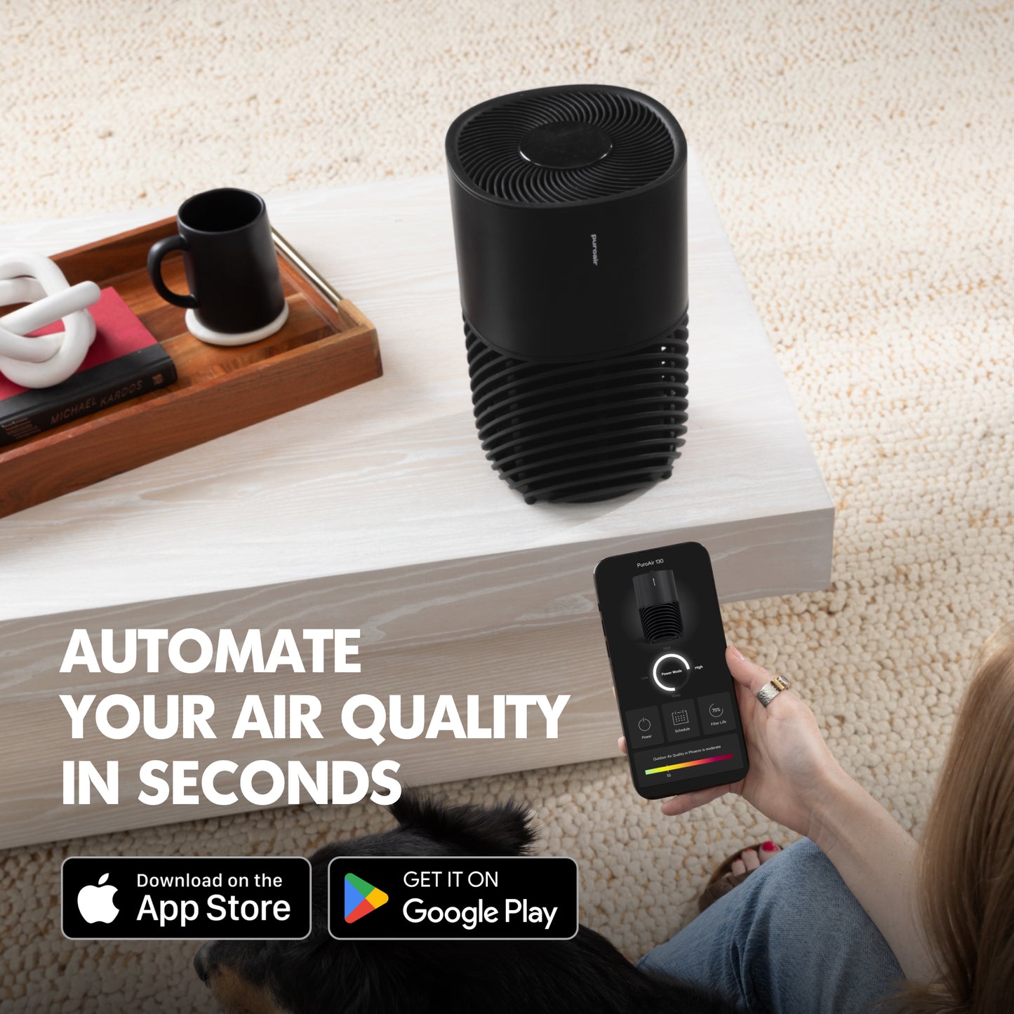 PuroAir 130i air purifier on a coffee table with a person using a smartphone app