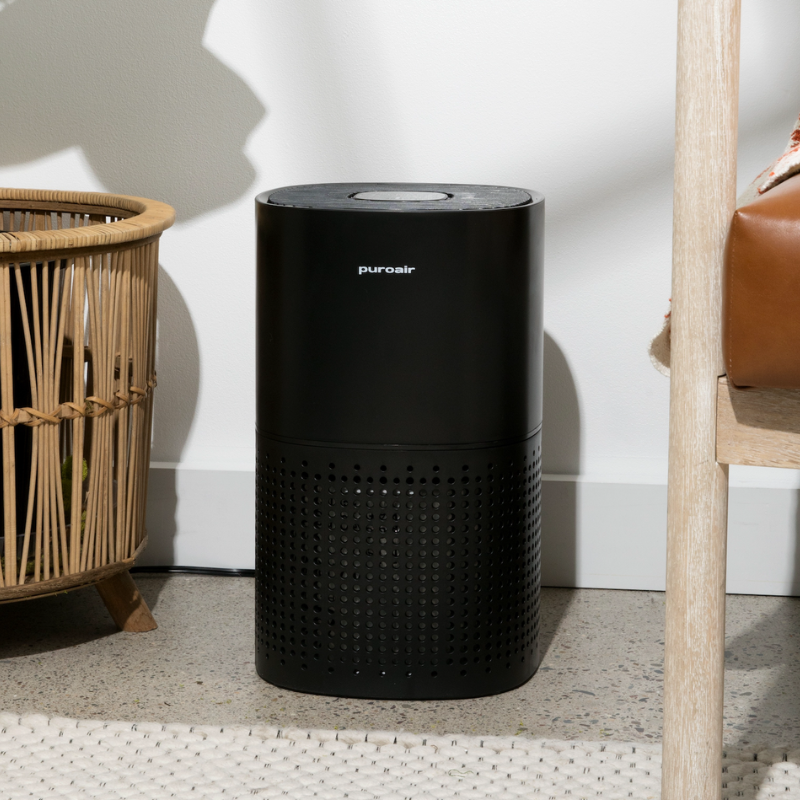 puroair 240 air purifier on floor by chair