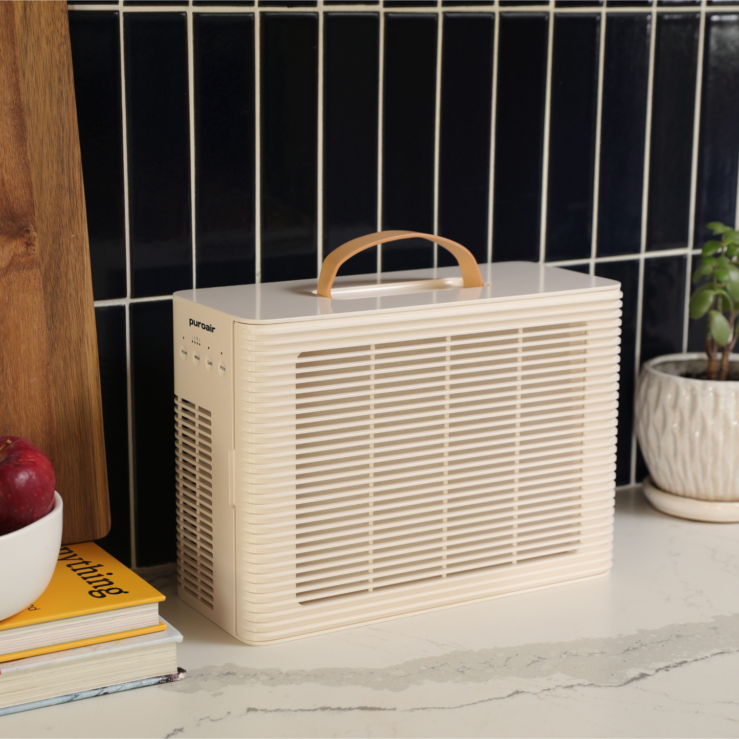 PuroAir PA101 on kitchen counter with dark tiled wall