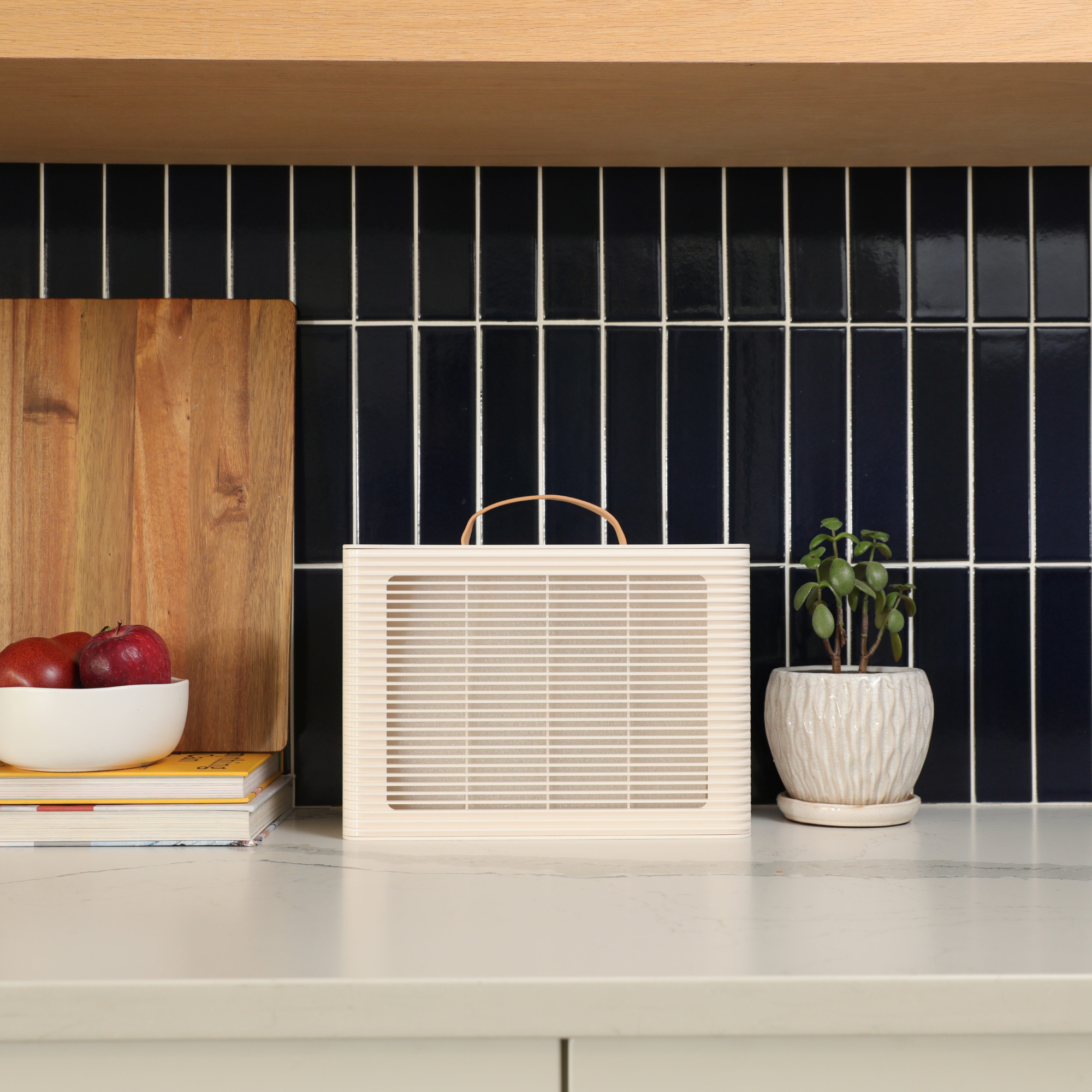 PuroAir PA101 on kitchen counter with dark tiled wall