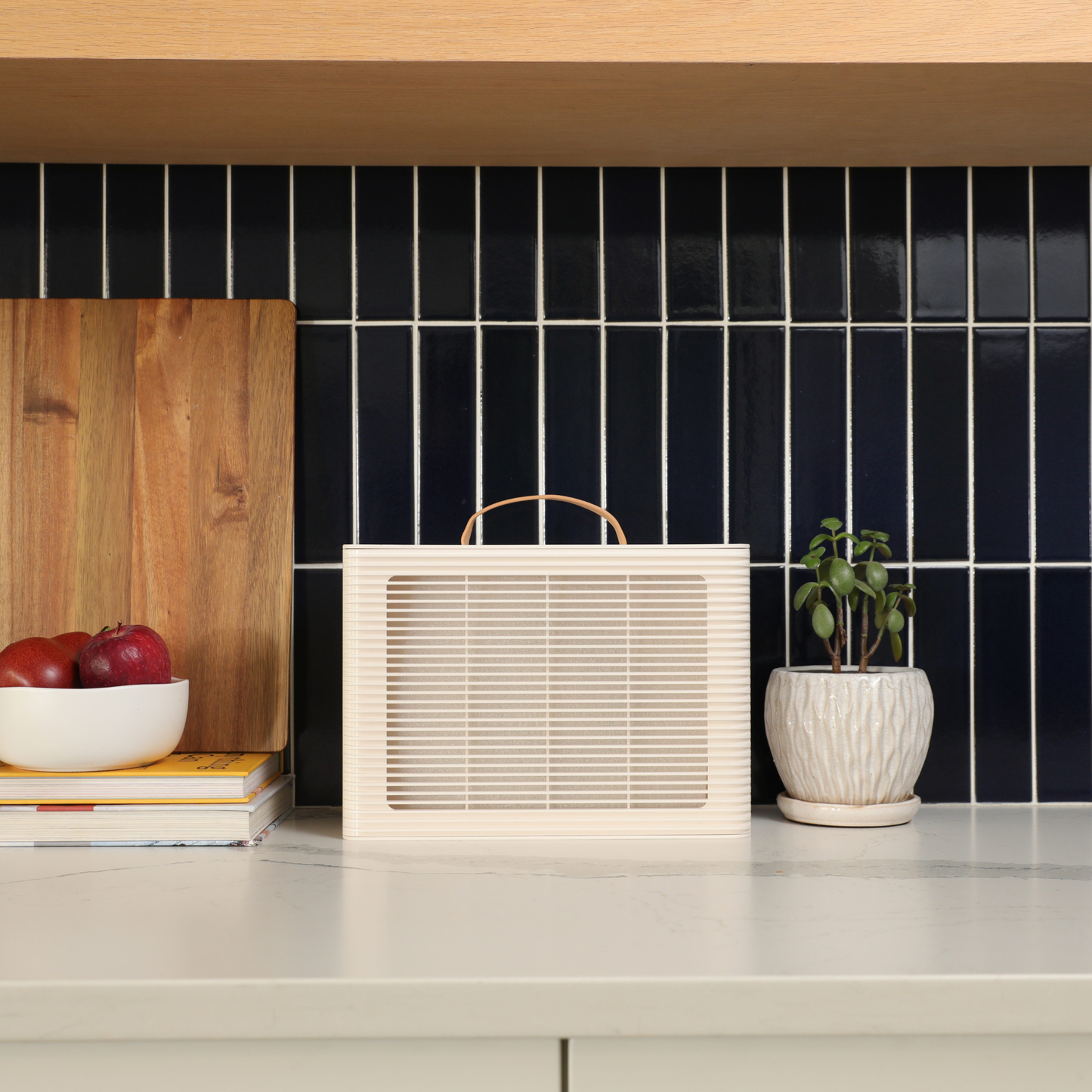 PuroAir PA101 on kitchen counter with dark tiled wall